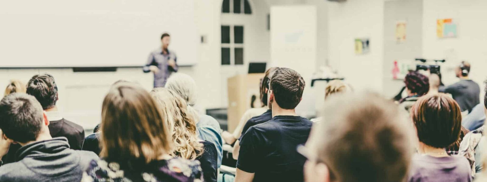 Man giving presentation in lecture hall at university.