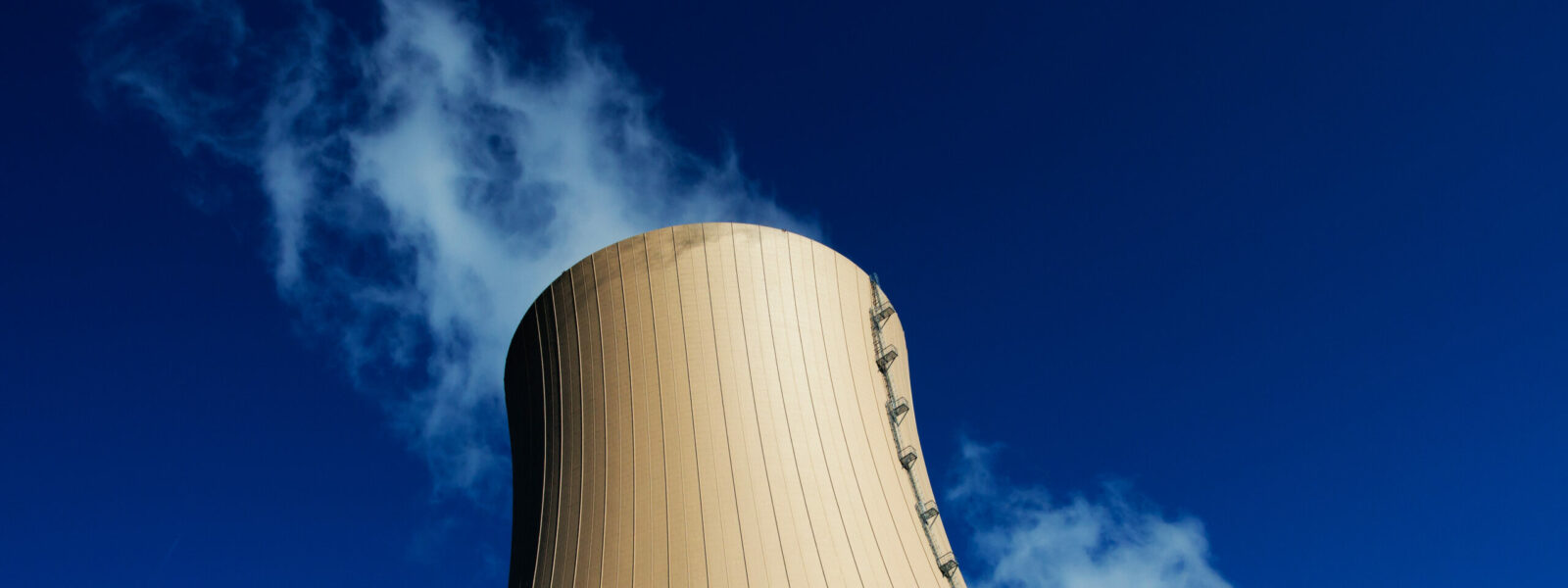 Cooling towers of nuclear power plant against  blue sky