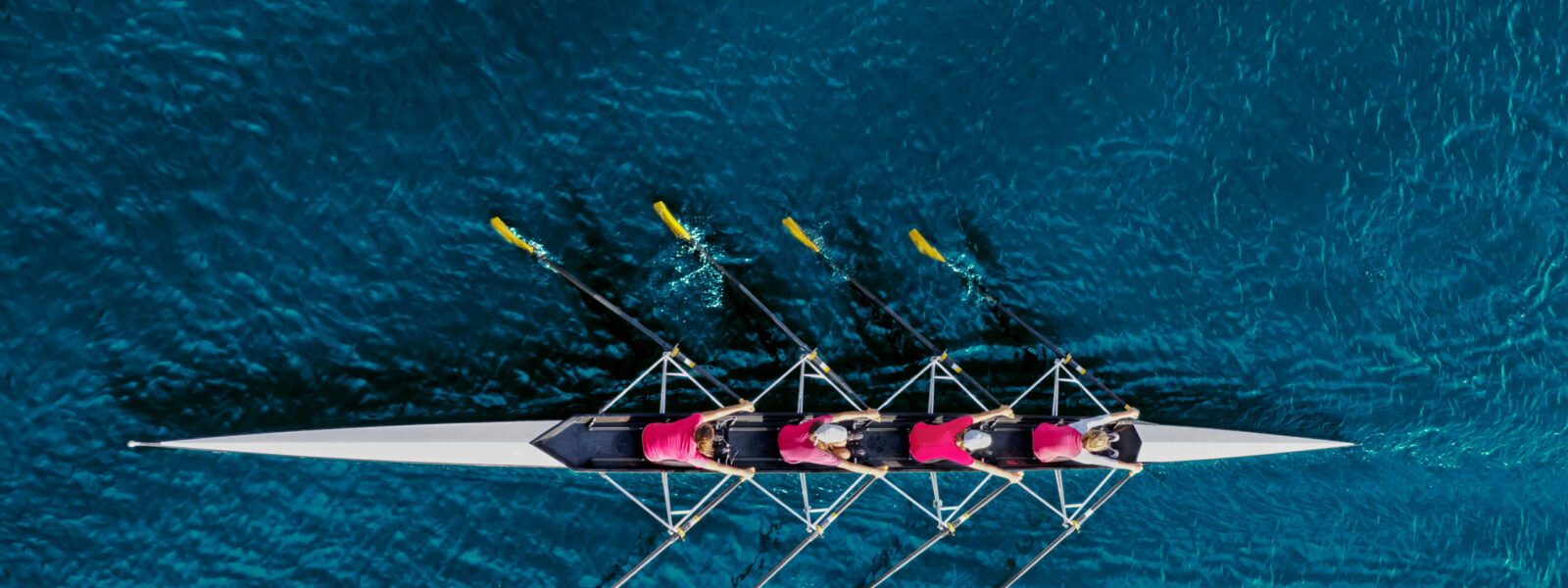 Women’s rowing team on blue water