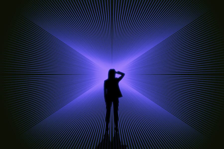 Conceptual image of businesswoman silhouette on bright blue lines background. Success, metaverse and direction concept.