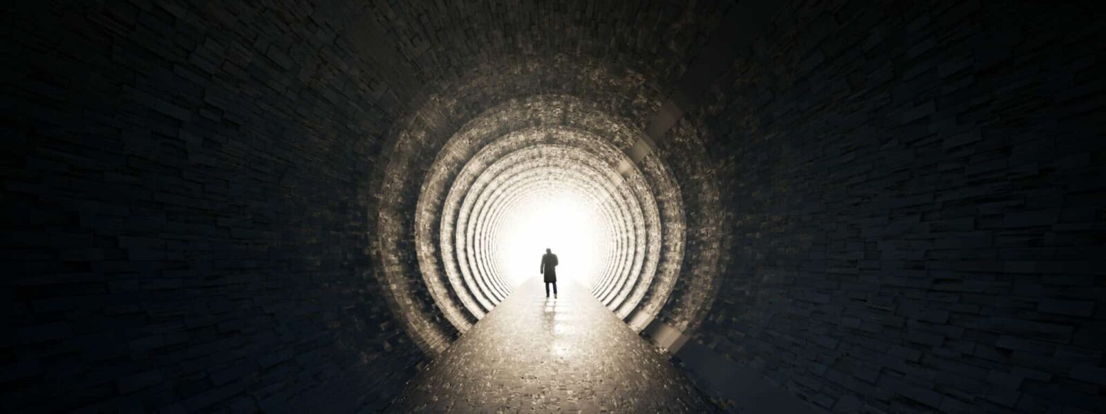 Concept or conceptual dark tunnel with a bright light at the end or exit as metaphor to success, faith, future or hope, a black silhouette of walking man to new opportunity or freedom 3d illustration