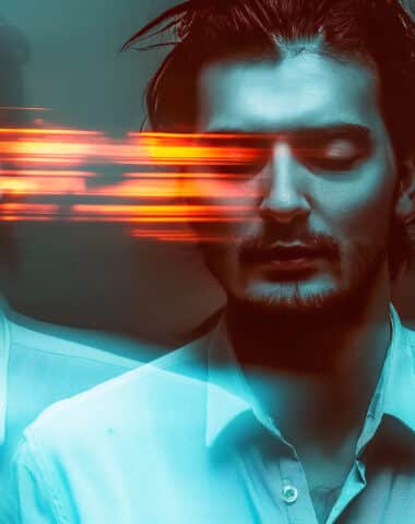 blurred portrait of a man with schizophrenic and mental disorders on a dark background. Stress and paranoia