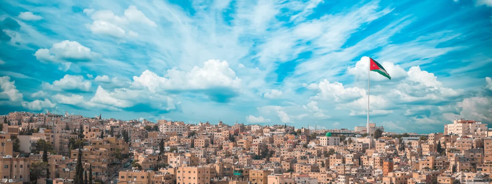 Scenic shot of the city of Amman with the Jordan flag in Jordan
