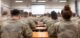 Soldiers attending class in military school learning from instructor
