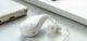 Close Up of White Hearing Aid Device on Clean Background Representing Assistive Technology