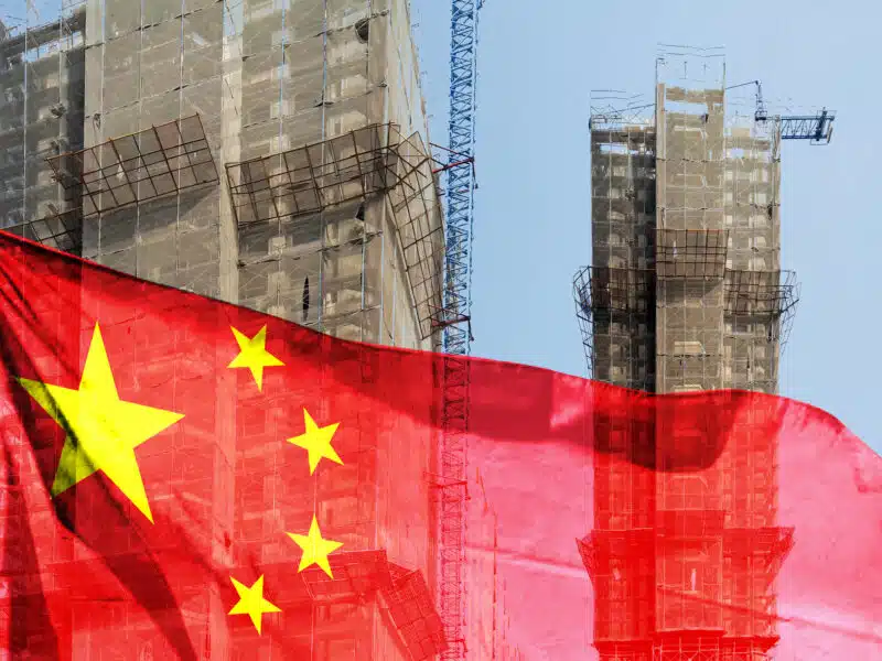Double exposure creative hologram of unfinished supertall building and Chinese flag