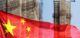 Double exposure creative hologram of unfinished supertall building and Chinese flag